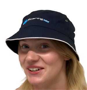 Person wearing a navy bucket hat with a brand logo on a white background